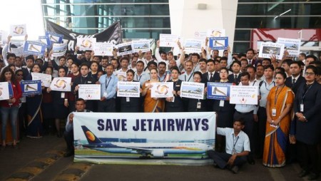Jet Airways employees hold placards as they gather for a silent march at Terminal 3 of the Indira Gandhi International Airport, in New Delhi on April 13, 2019. - India's Jet Airways extended a suspension of all of its international flights until April 15, the latest blow to the debt-stricken carrier battling to stay afloat. The development on April 12 came after the government said it would investigate Jet's ability to continue flying as lenders seek a buyer to keep the beleaguered airline running. (Photo by STR / AFP)