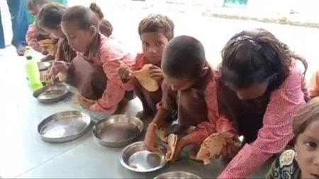 Children get roti and salt as a midday meal in Mirzapur
