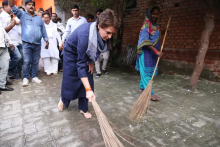 Drama Queen! -Surrounded By Congress Workers With Cameras, Priyanka Gandhi Vadra Sweeps Ground At Dalit Locality In Lucknow